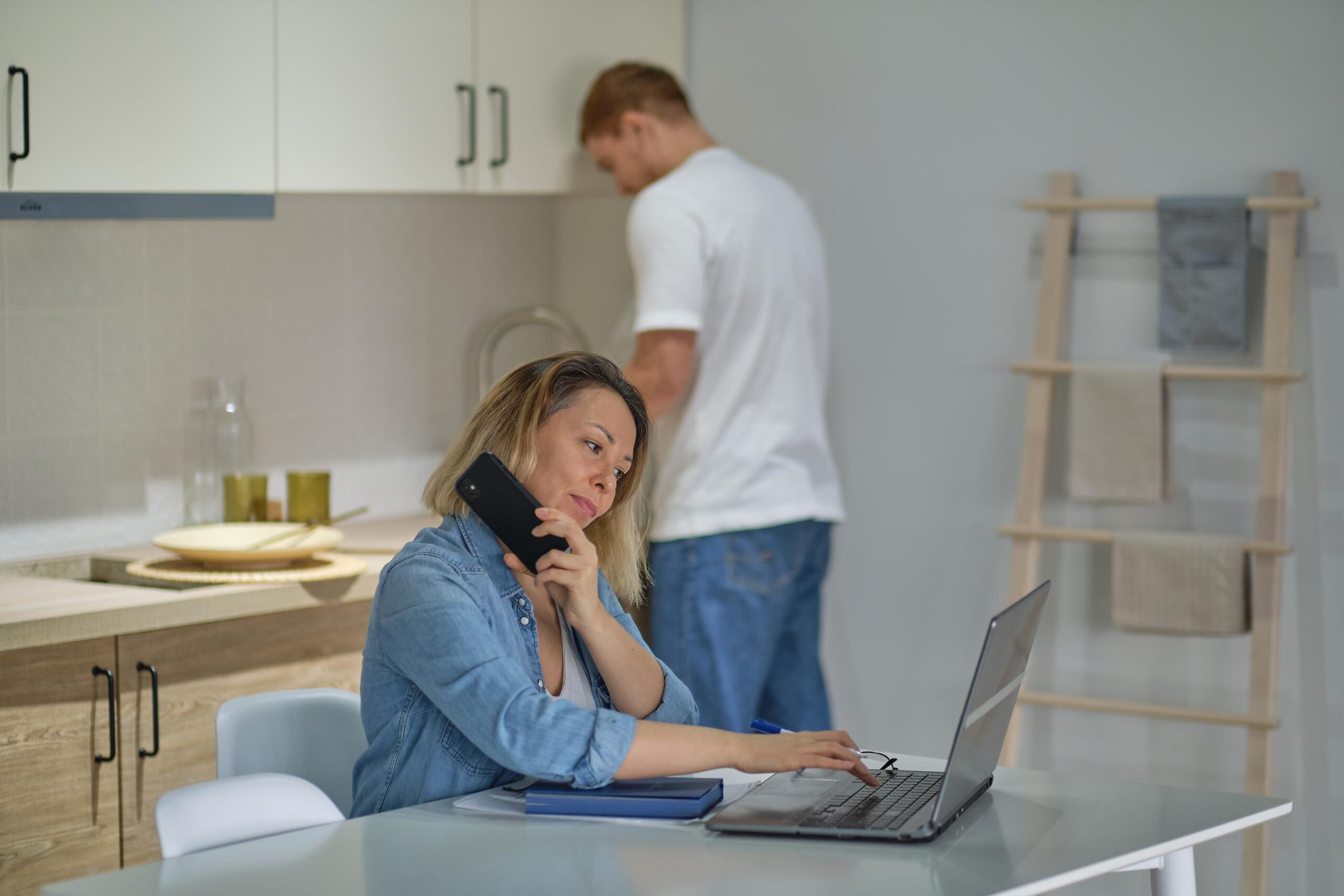 Person on phone in modern kitchen