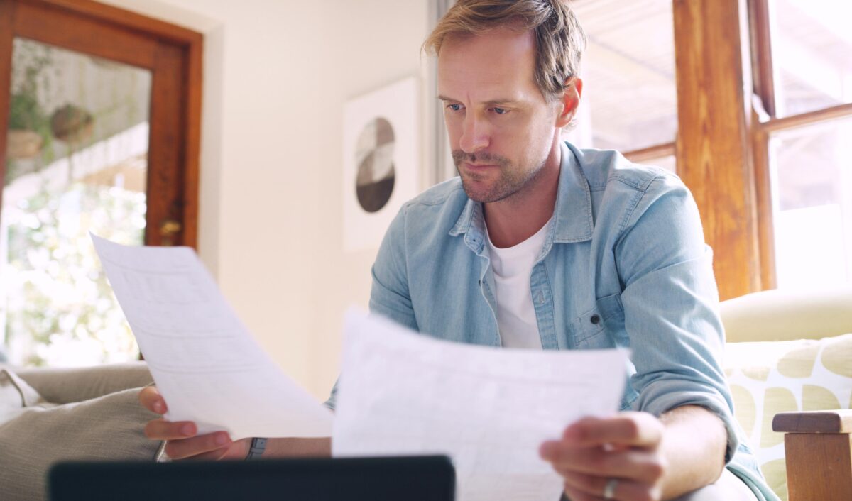Man Reviews Documents While Working at Home