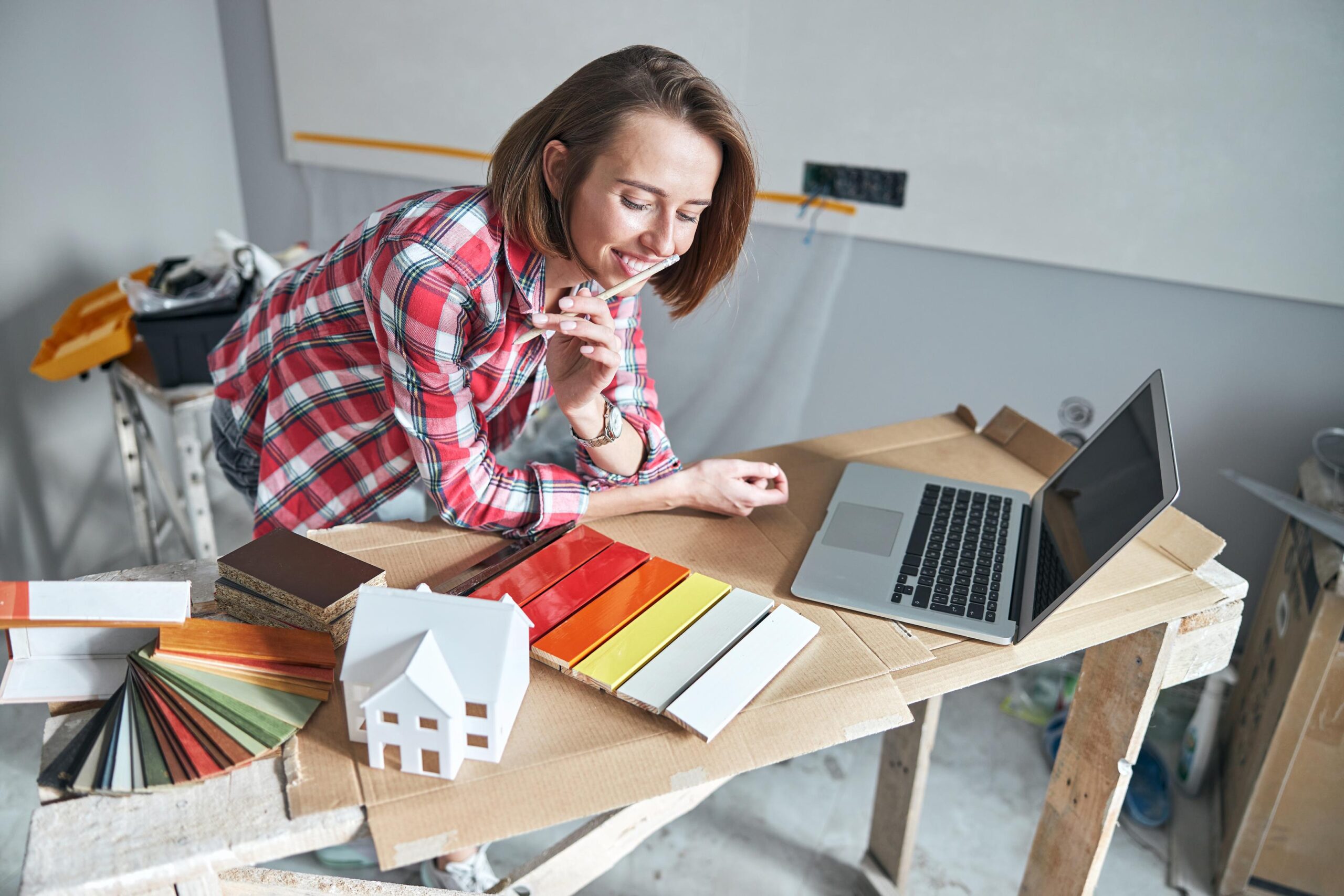 Pleased interior designer examining the colored fiberboard sample kit